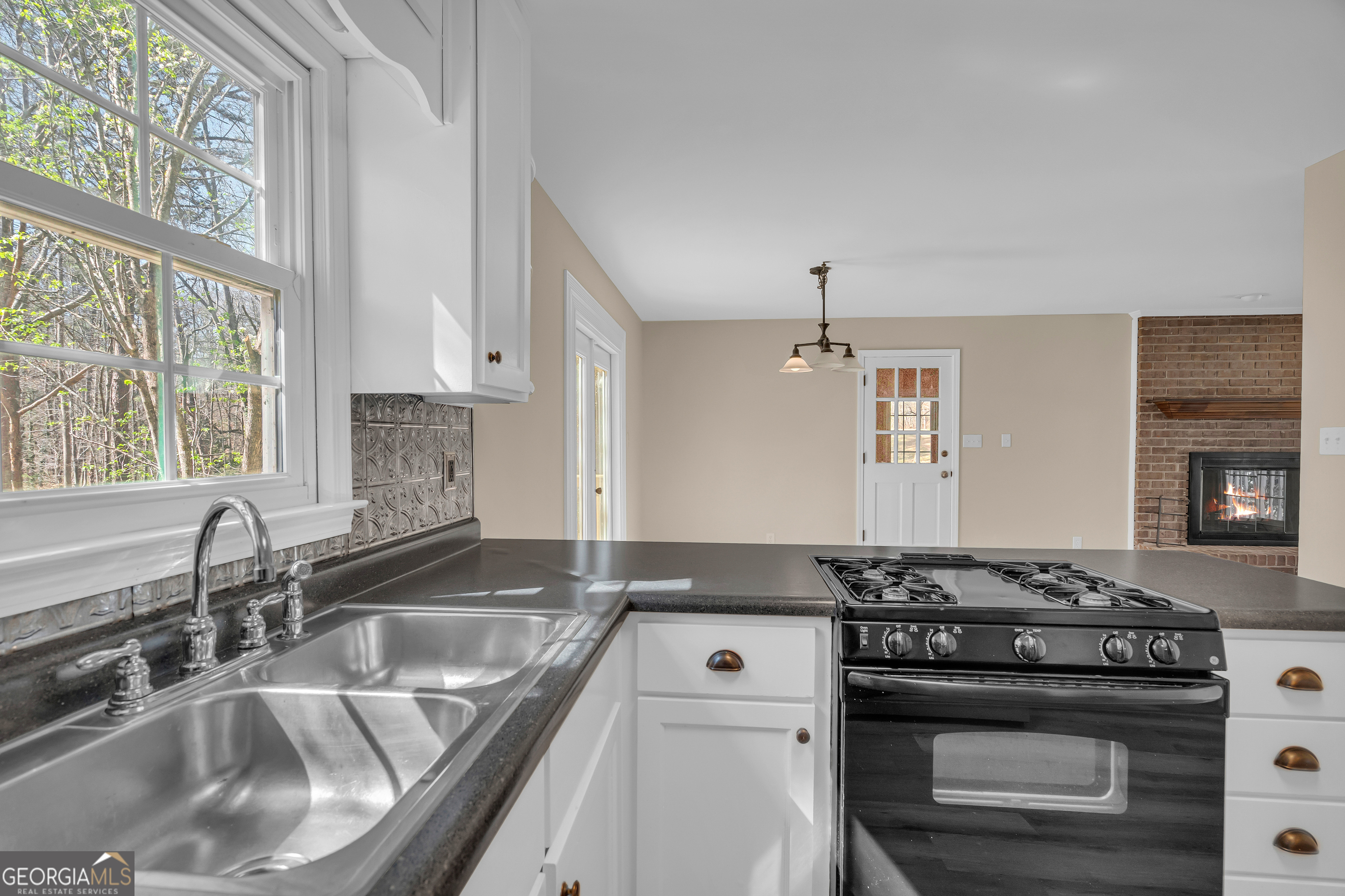 694 Lovers Lane Toccoa, GA 30577 - Photo 28 of 50 a kitchen that has a sink and a stove
