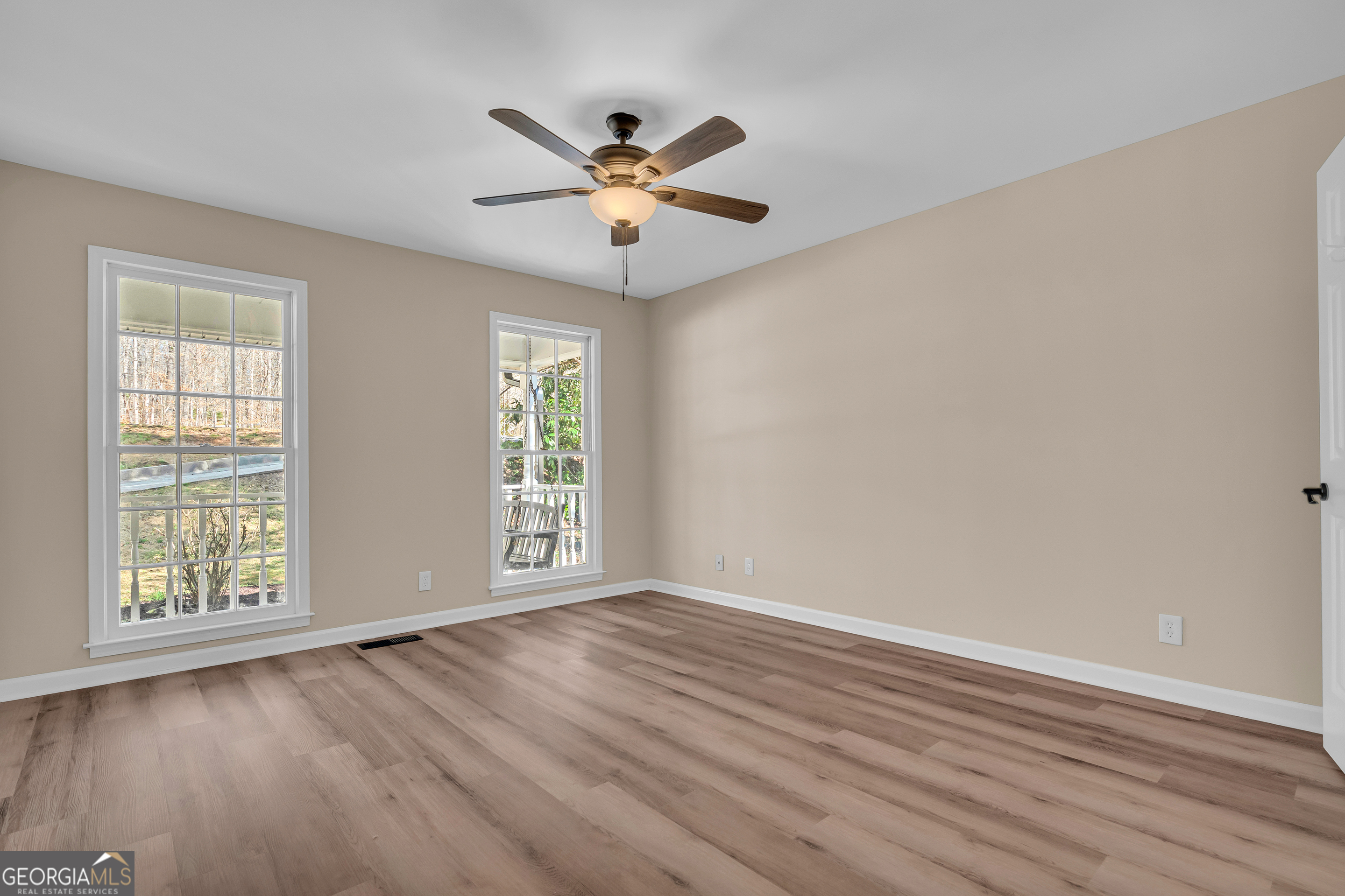 694 Lovers Lane Toccoa, GA 30577 - Photo 31 of 50 a view of an empty room with wooden floor and a window