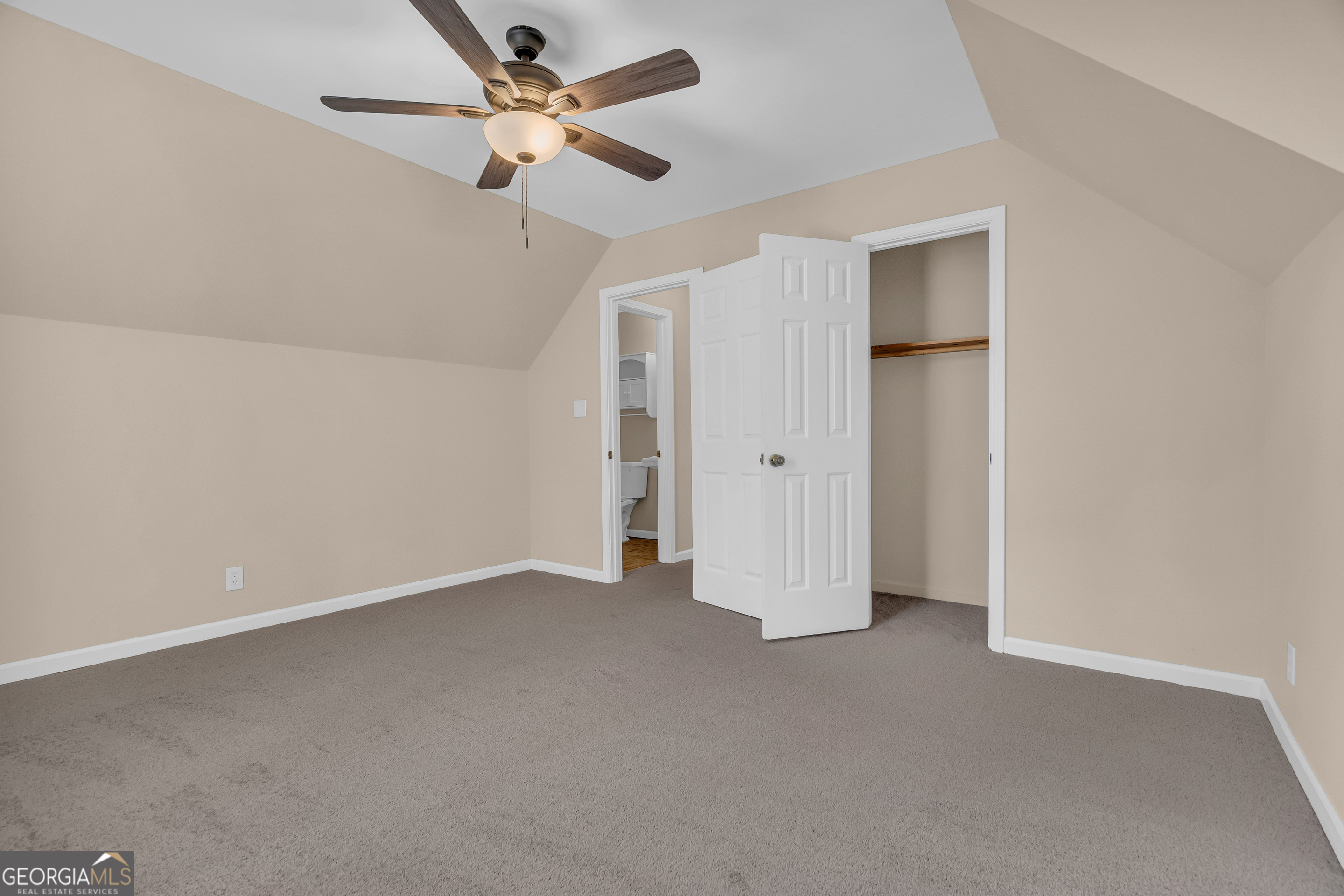 694 Lovers Lane Toccoa, GA 30577 - Photo 43 of 50 an empty room with closet and a ceiling fan