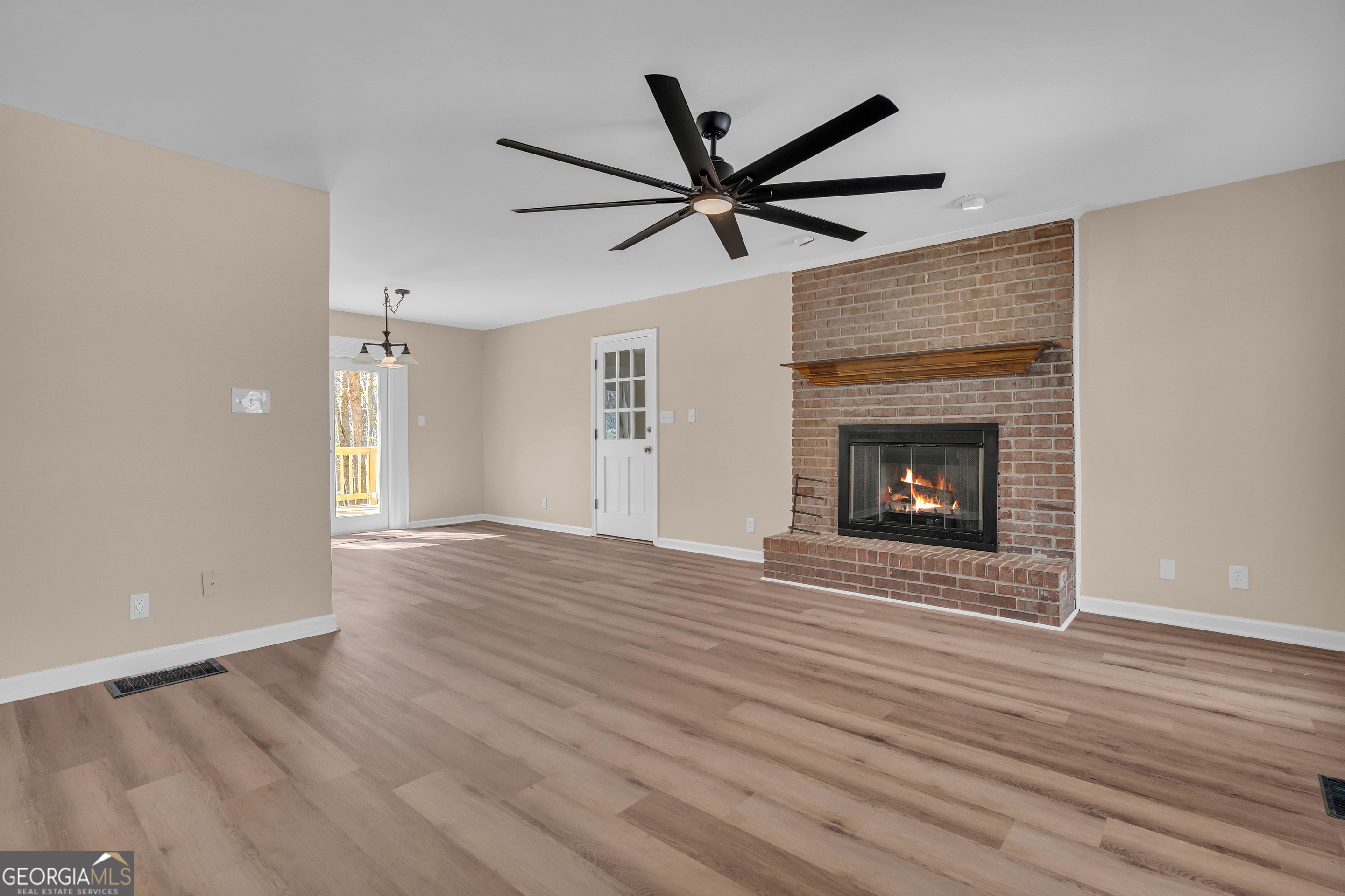 694 Lovers Lane Toccoa, GA 30577 - Photo 6 of 50 a view of empty room with wooden floor and fireplace