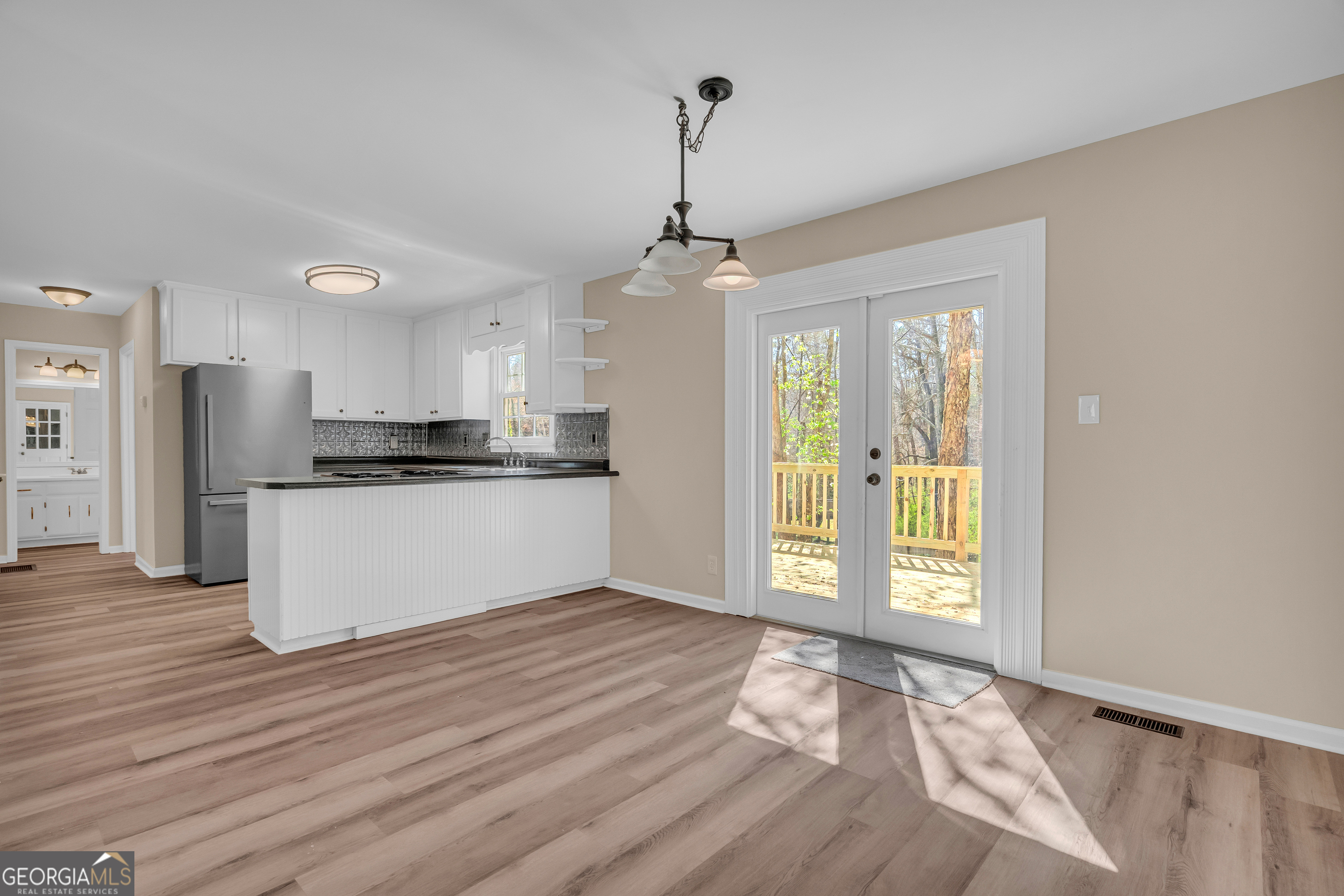 694 Lovers Lane Toccoa, GA 30577 - Photo 7 of 50 a view of a kitchen with a stove wooden floor and a kitchen