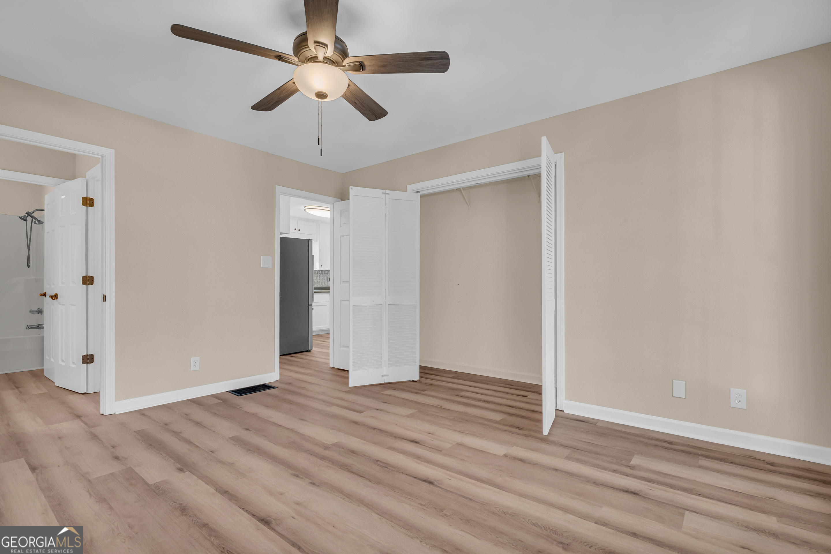 694 Lovers Lane Toccoa, GA 30577 - Photo 10 of 50 an empty room with wooden floor and ceiling fan