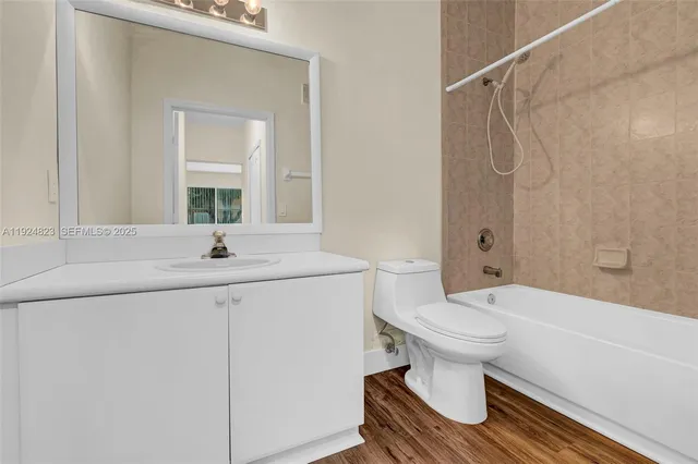 a view of a room with wooden floor and window