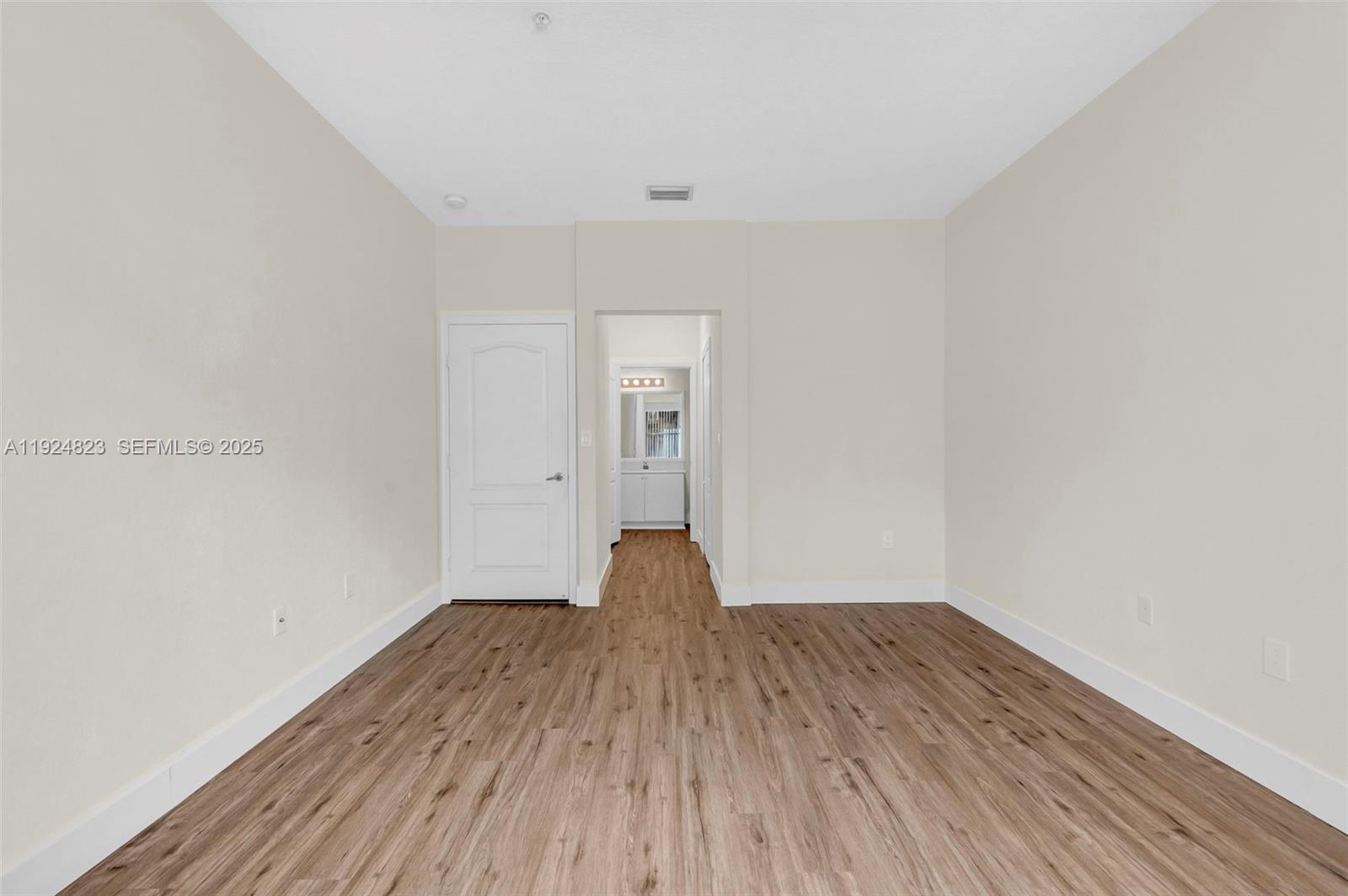 7250 Northwest 177th Street, Unit 10216 Hialeah, FL 33015 - Photo 16 of 23 a view of a room with wooden floor and window