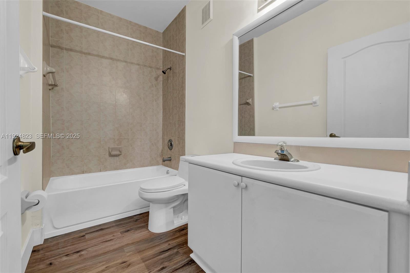 7250 Northwest 177th Street, Unit 10216 Hialeah, FL 33015 - Photo 19 of 23 a bathroom with a sink a toilet and a bathtub