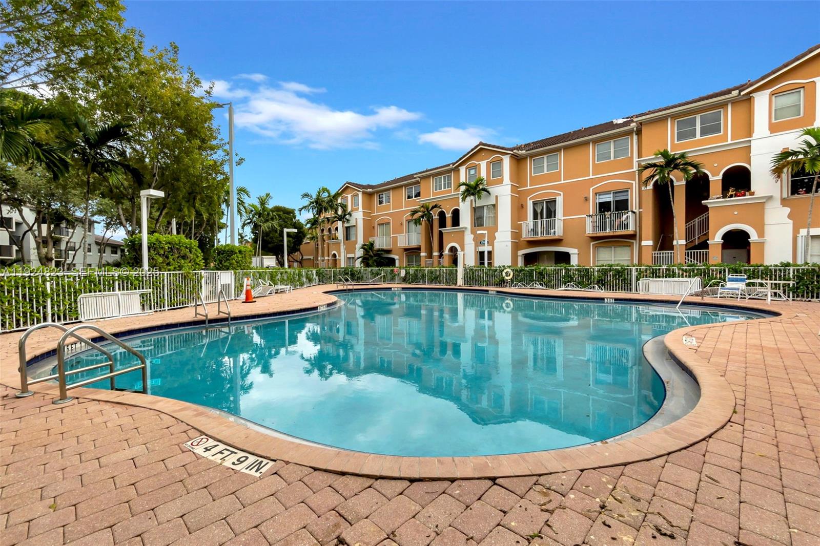 7250 Northwest 177th Street, Unit 10216 Hialeah, FL 33015 - Photo 20 of 23 a view of a swimming pool with a lake view