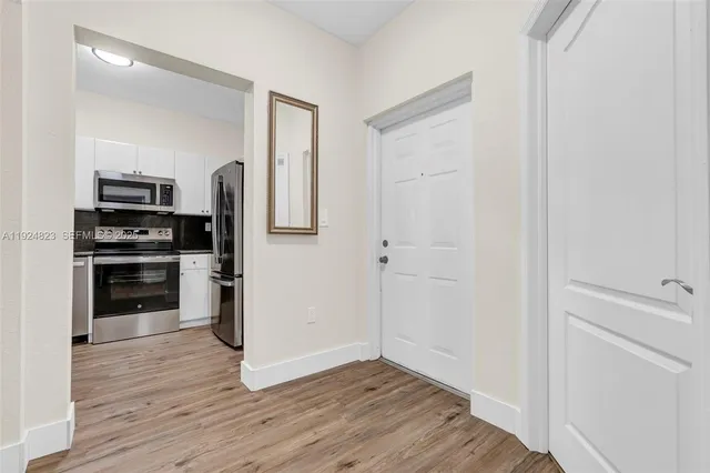 a kitchen with granite countertop a sink and cabinets