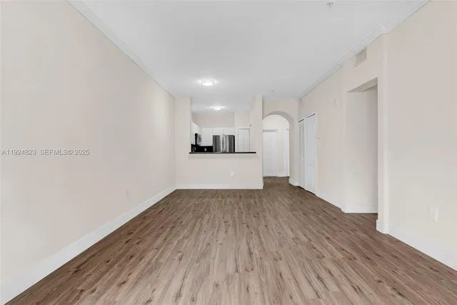 a walk in closet with wooden floor