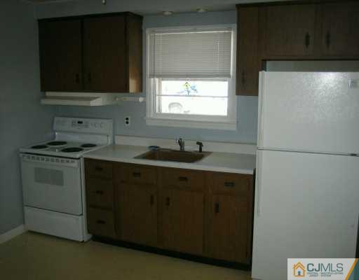 144 South Hill Road Colonia, NJ 07067 - Photo 3 of 8 a kitchen with a sink stove and microwave