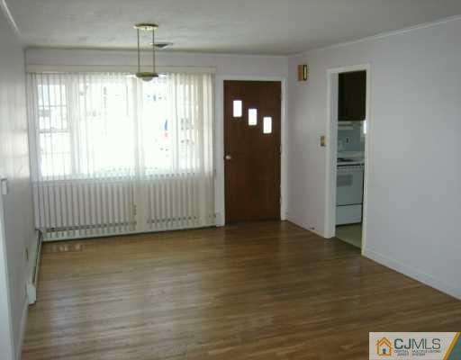 144 South Hill Road Colonia, NJ 07067 - Photo 4 of 8 an empty room with wooden floor and windows