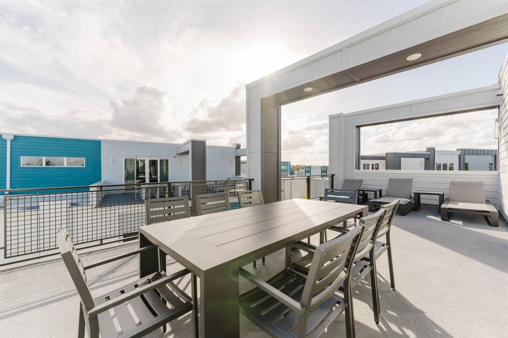 7760 Sandy Ridge Drive, Unit 226 Reunion, FL 34747 - Photo 35 of 40 a view of a patio with table and chairs