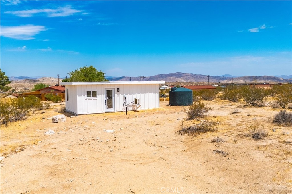 777 Quail Bush Road Landers, CA 92285 - Photo 24 of 46 a view of a house with a yard