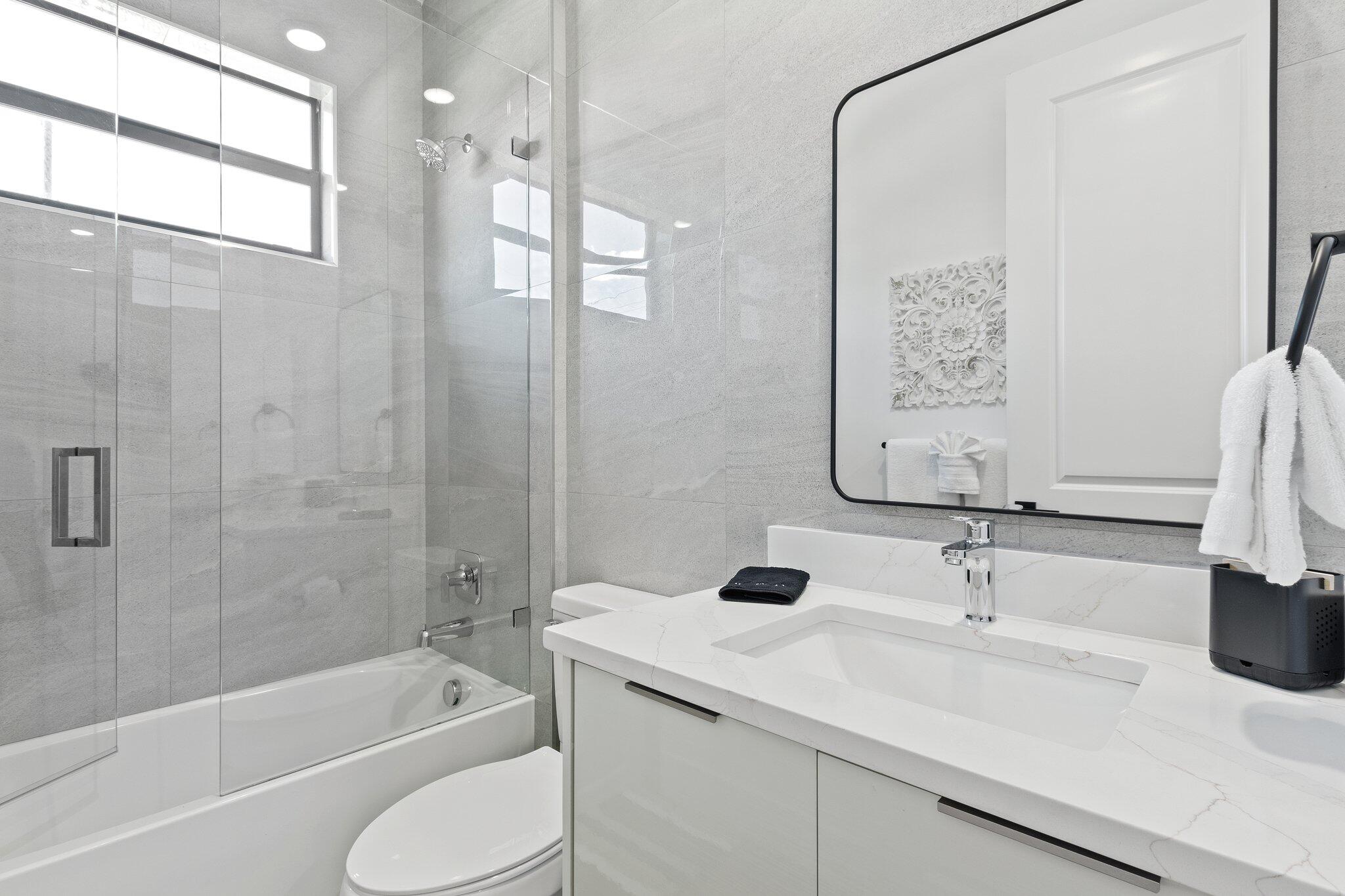 601 Southwest 3rd Street Delray Beach, FL 33444 - Photo 25 of 75 a bathroom with a sink toilet tub and shower