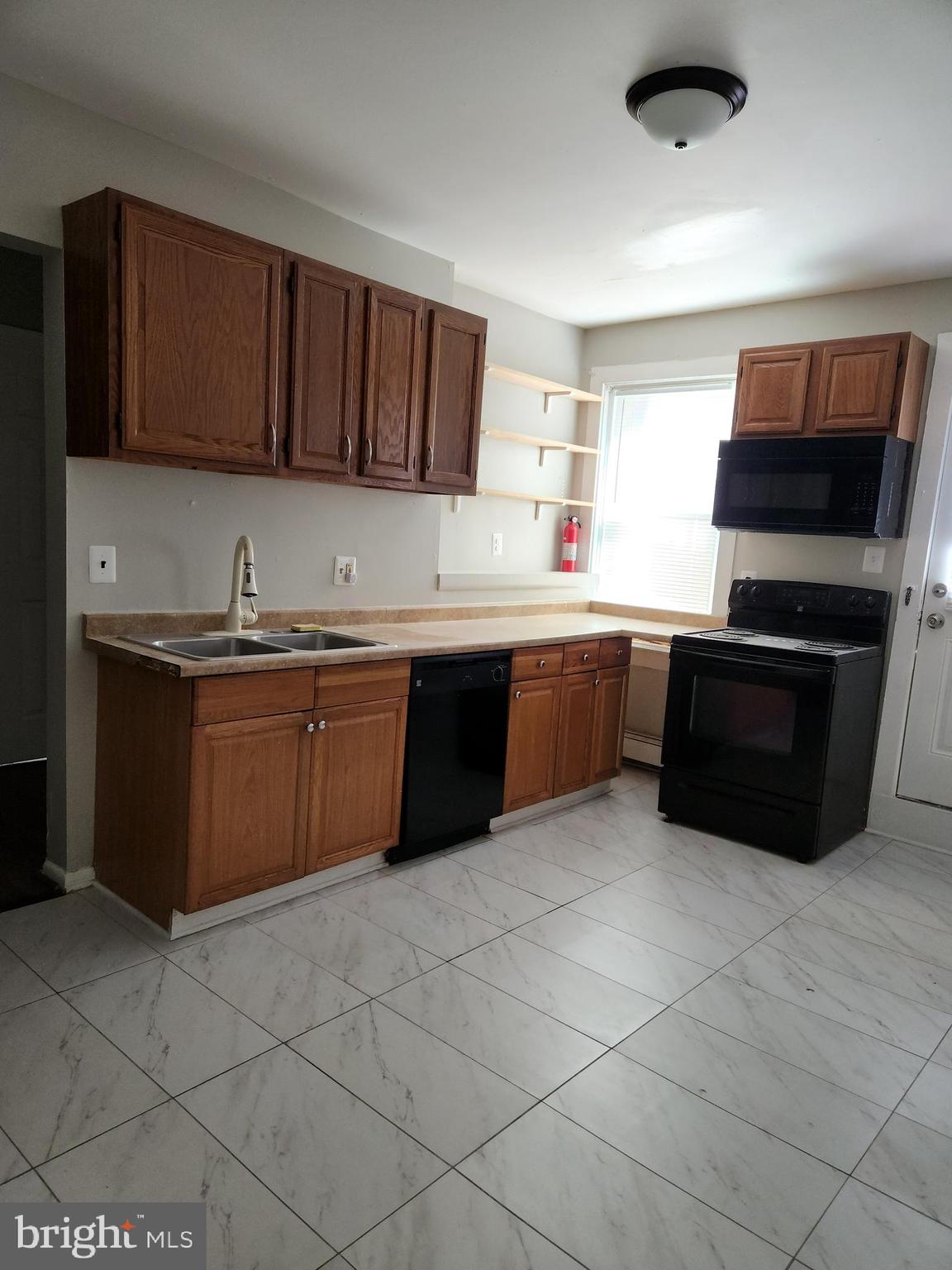 2204 North Jefferson Street, Unit 2 Wilmington, DE 19802 - Photo 8 of 10 a kitchen with a sink a stove and cabinets