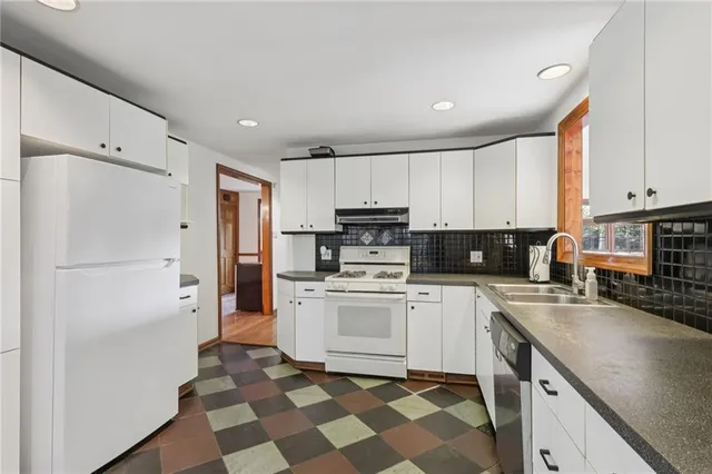 a kitchen with stainless steel appliances granite countertop refrigerator sink and cabinets