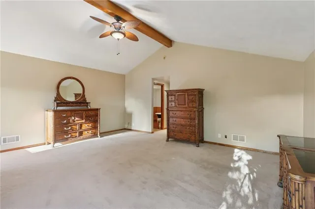 a view of an empty room with a fireplace and a chandelier
