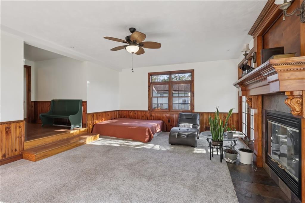 2549 West Hardies Road Gibsonia, PA 15044 - Photo 6 of 34 a spacious bedroom with a bed a fireplace and a chandelier