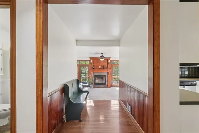 a view of a hallway with wooden floor and furniture