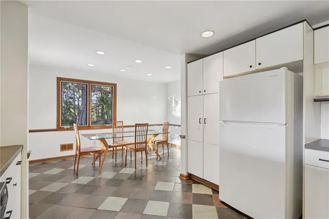 a dining room with furniture and a window