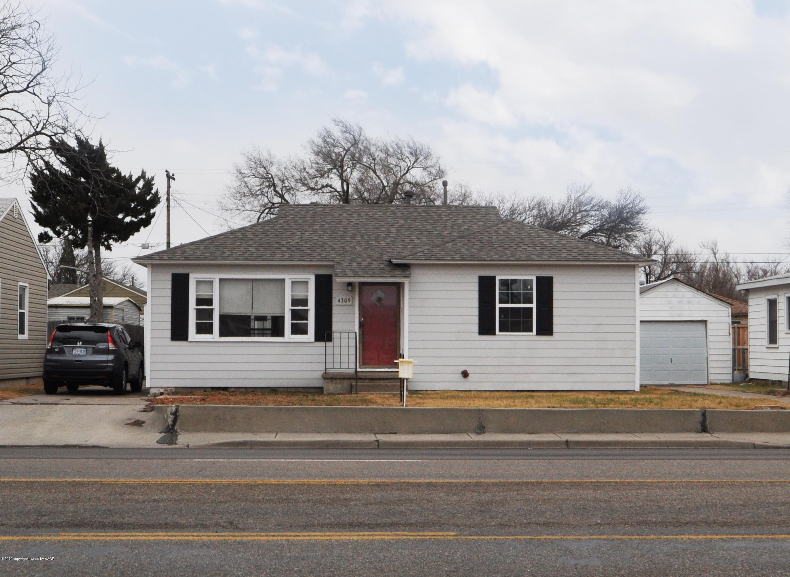 4309 South Washington Street Amarillo, TX 79110 - Photo 1 of 12 a view of a house with a small garden