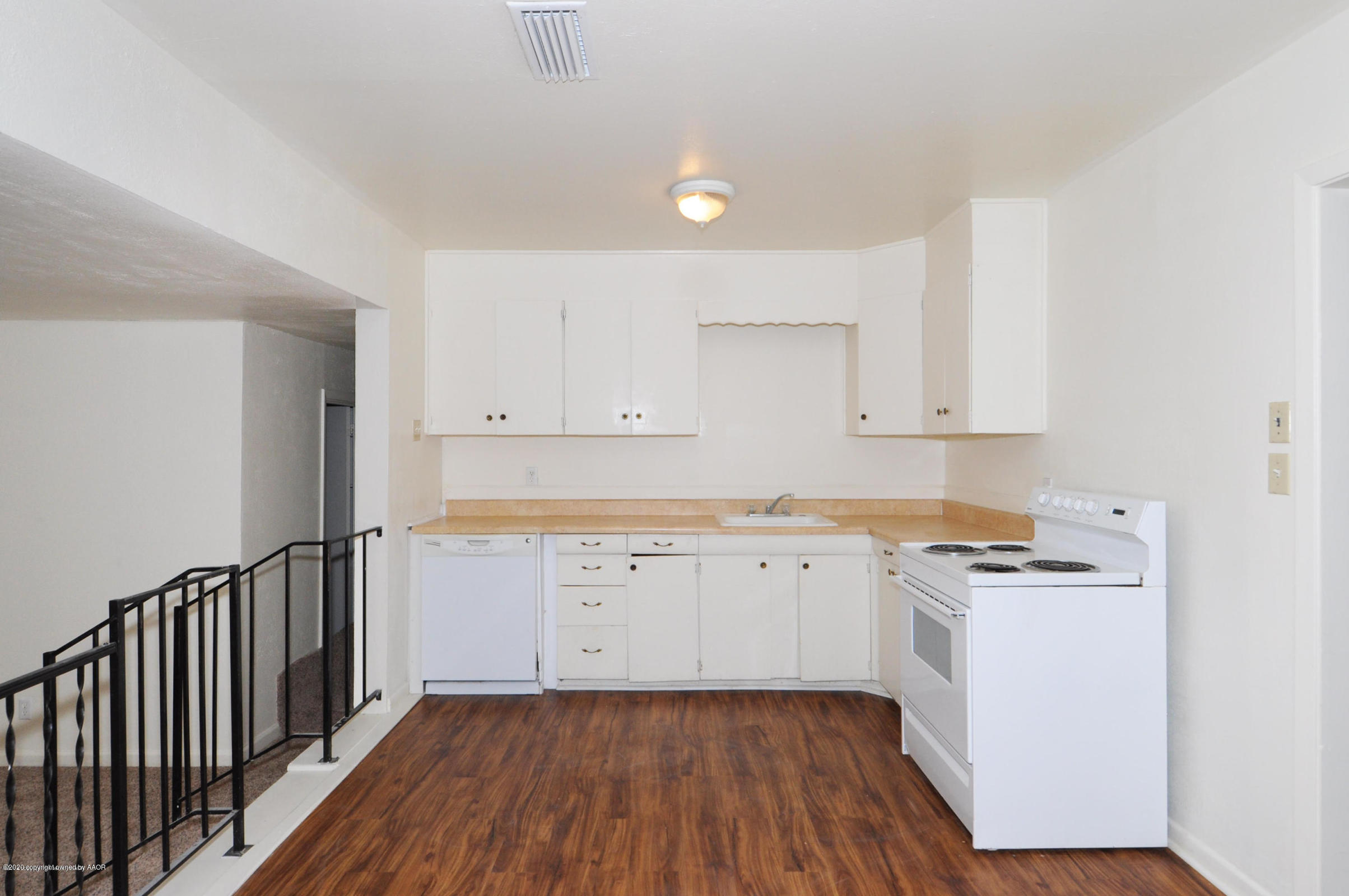 4309 South Washington Street Amarillo, TX 79110 - Photo 4 of 12 a kitchen with sink cabinets and wooden floor