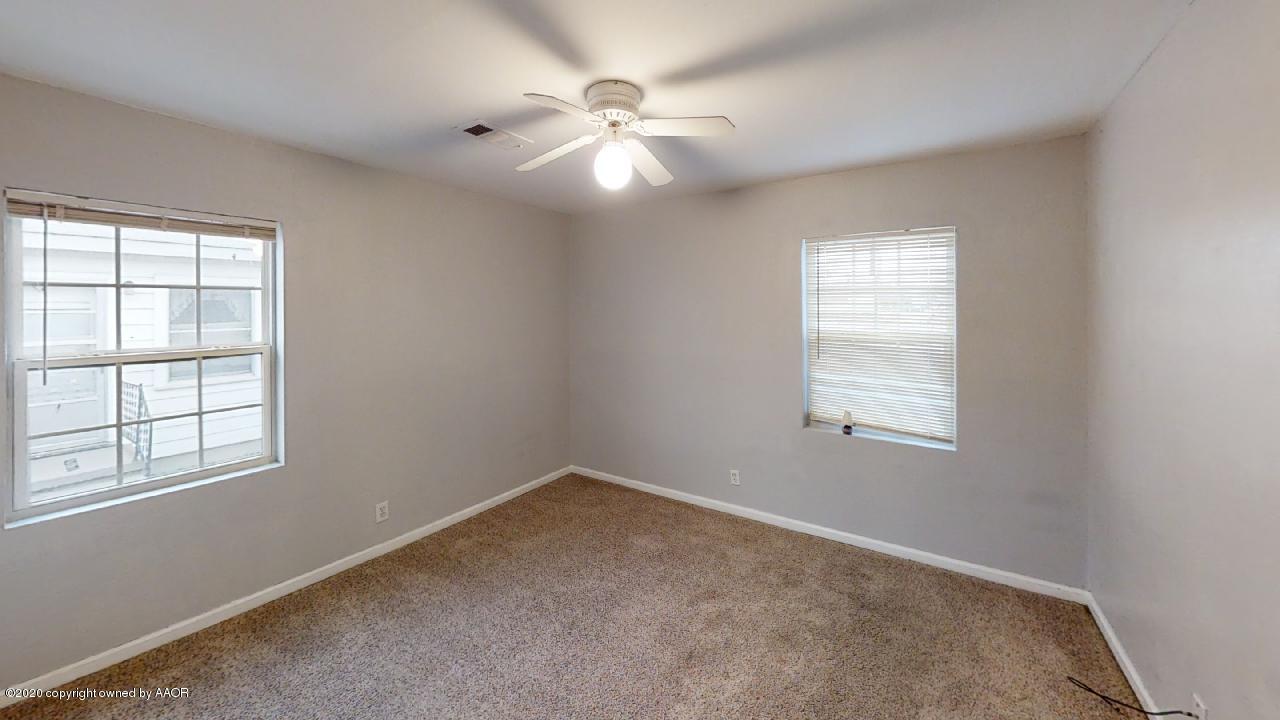 4309 South Washington Street Amarillo, TX 79110 - Photo 6 of 12 an empty room with windows and chandelier fan