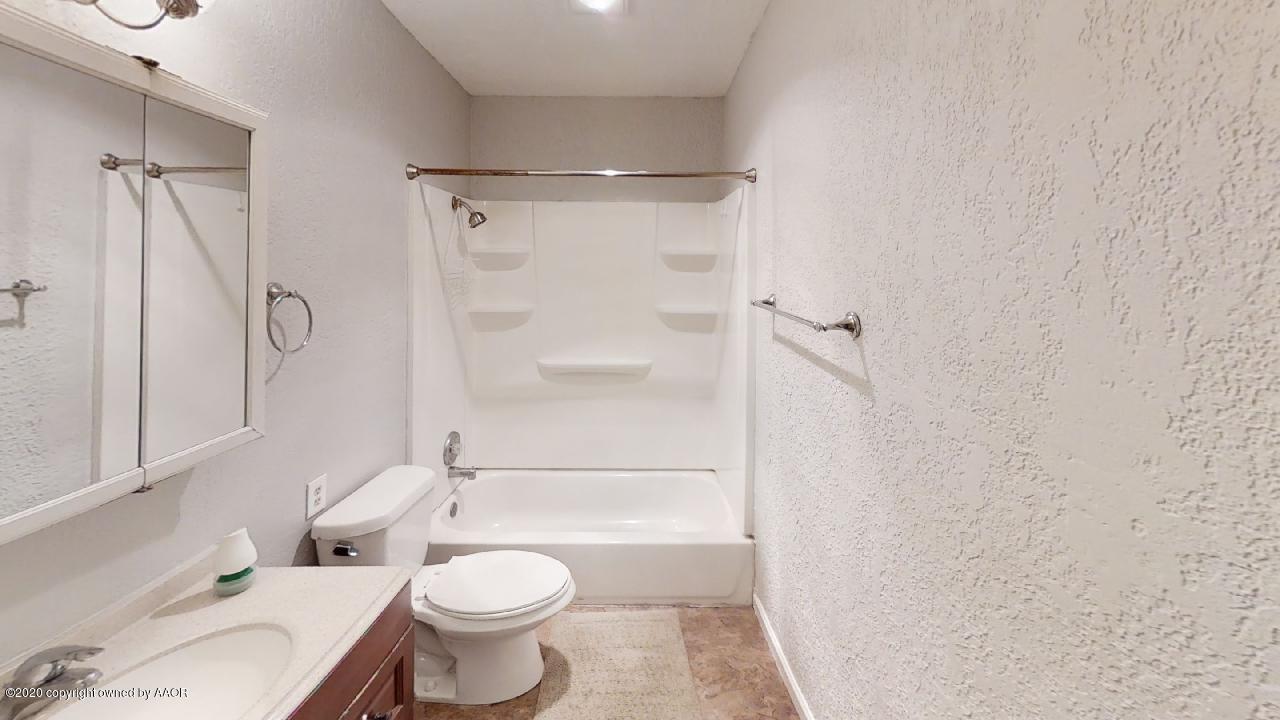 4309 South Washington Street Amarillo, TX 79110 - Photo 9 of 12 a bathroom with a toilet sink and shower