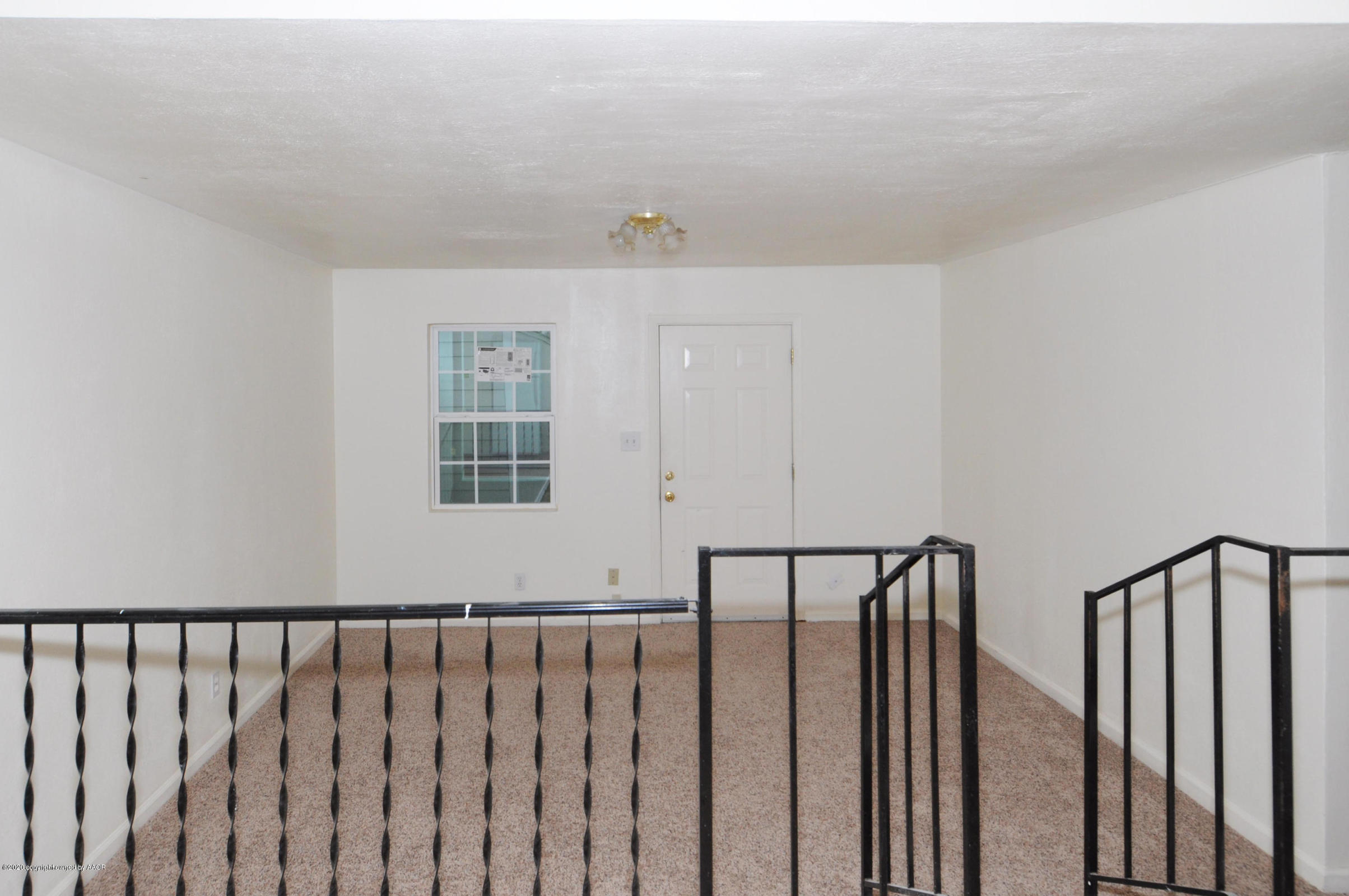 4309 South Washington Street Amarillo, TX 79110 - Photo 10 of 12 a view of a hallway with wooden floor and stairs