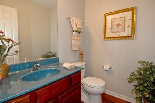 927 Oak Ridge Boulevard Elgin, IL 60120 - Photo 5 of 10 a bathroom with a granite countertop toilet a sink and a mirror
