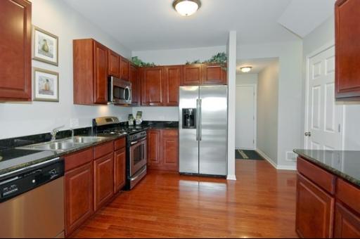 927 Oak Ridge Boulevard Elgin, IL 60120 - Photo 6 of 10 a kitchen with stainless steel appliances granite countertop a refrigerator a stove and a sink