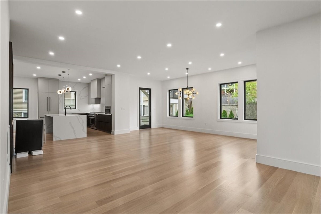116 Thorndike Street Brookline, MA 02446 - Photo 25 of 42 a view of kitchen with kitchen island refrigerator wooden floor and window