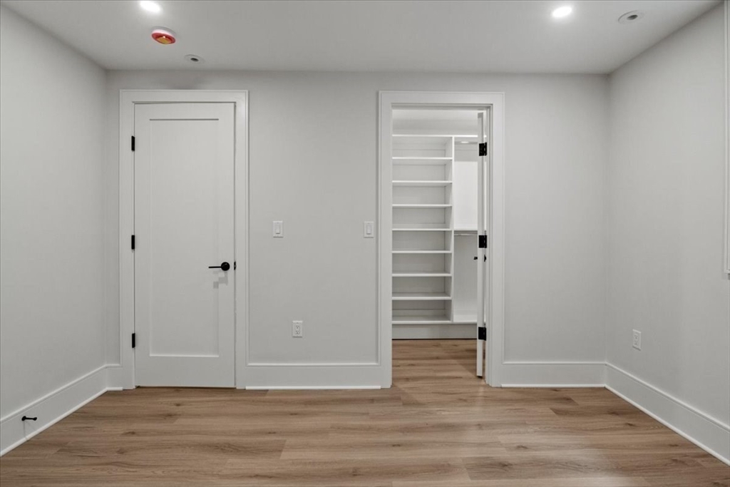 116 Thorndike Street Brookline, MA 02446 - Photo 30 of 42 a view of an empty room with wooden floor