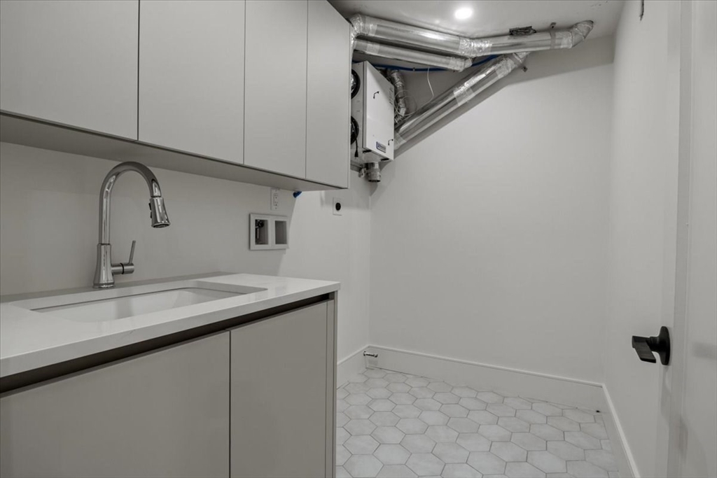 116 Thorndike Street Brookline, MA 02446 - Photo 36 of 42 a bathroom with a sink and vanity