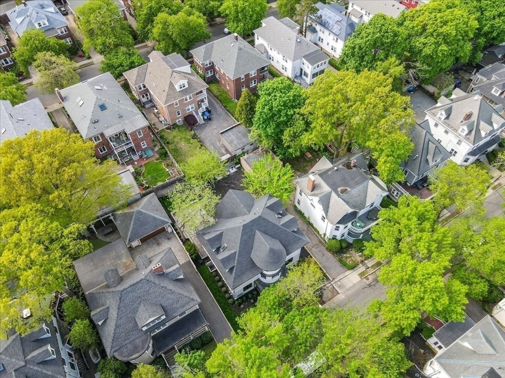 116 Thorndike Street Brookline, MA 02446 - Photo 41 of 42 an aerial view of a house with a yard and garden