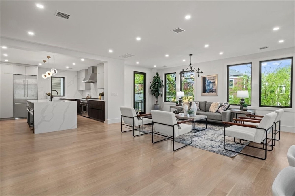 116 Thorndike Street Brookline, MA 02446 - Photo 6 of 42 a living room with furniture and a large window