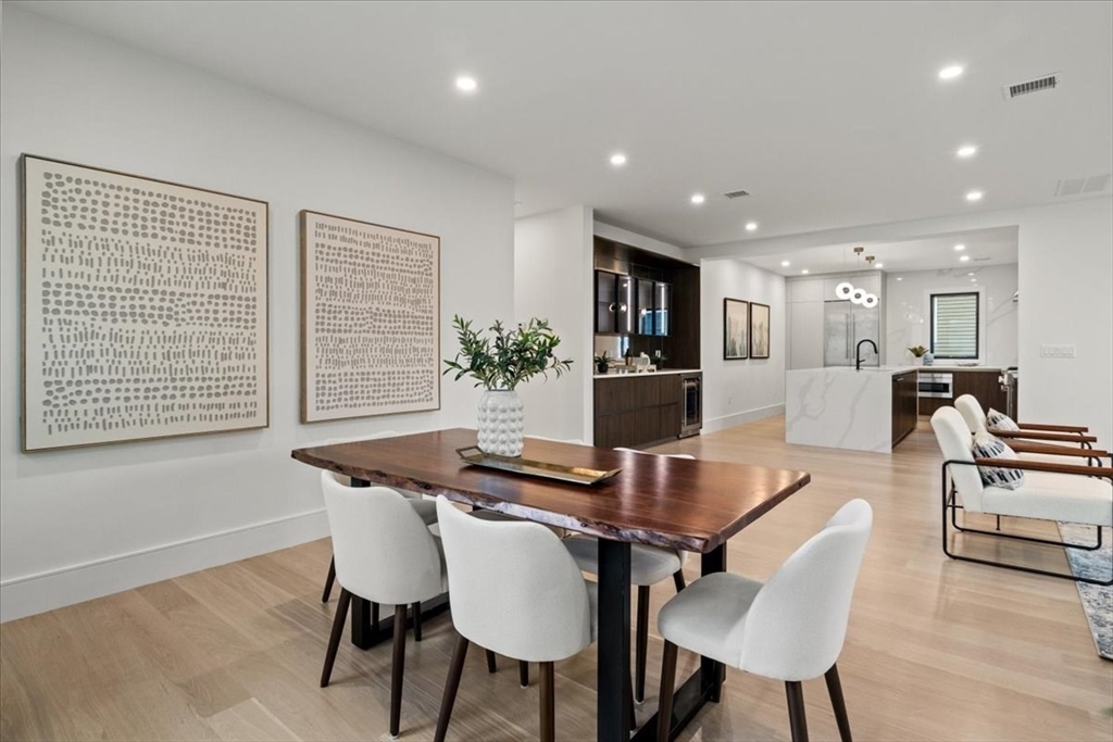 116 Thorndike Street Brookline, MA 02446 - Photo 10 of 42 a view of a dining room with furniture and wooden floor