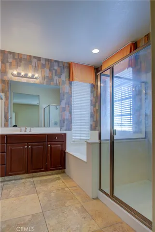 a bathroom with a sink mirror and a bathtub