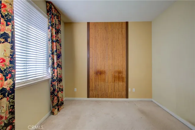 a view of a small space with window and a wooden floor