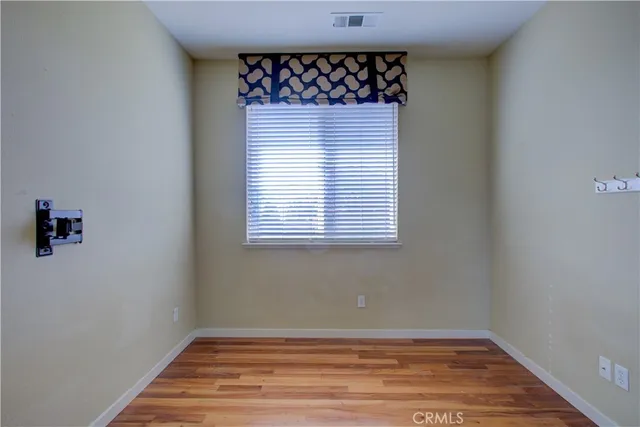 a view of a hallway with wooden floor and closet