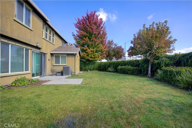 a view of a field of grass and trees