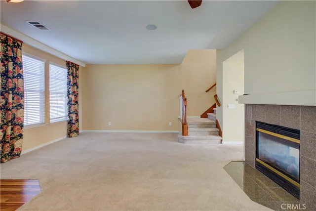 a view of an empty room with a fireplace