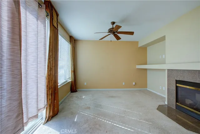 a view of a livingroom with a fireplace and cabinet