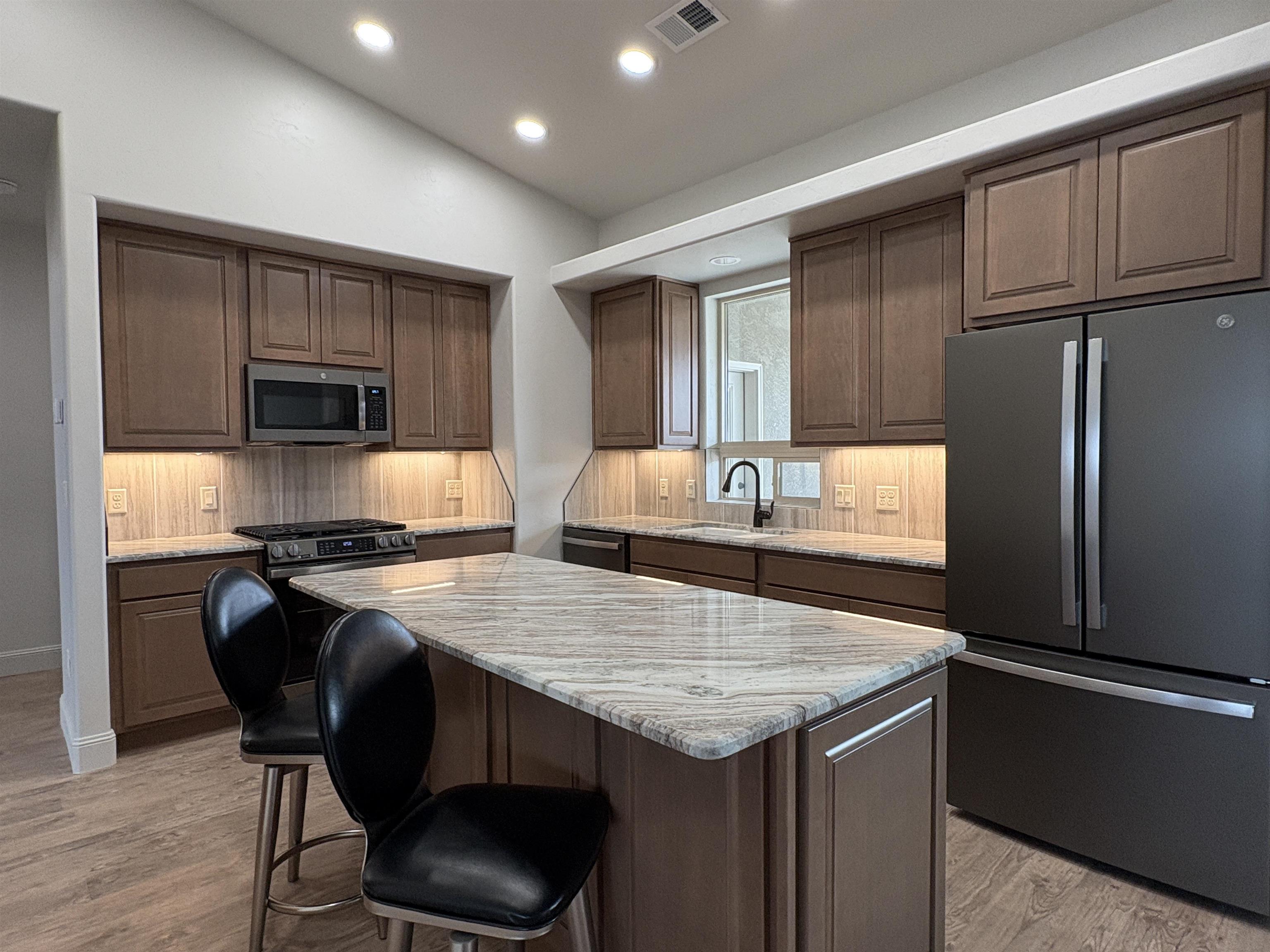 2629 Emerald Ridge Lane Grand Junction, CO 81506 - Photo 12 of 36 a kitchen with granite countertop a stove and a refrigerator