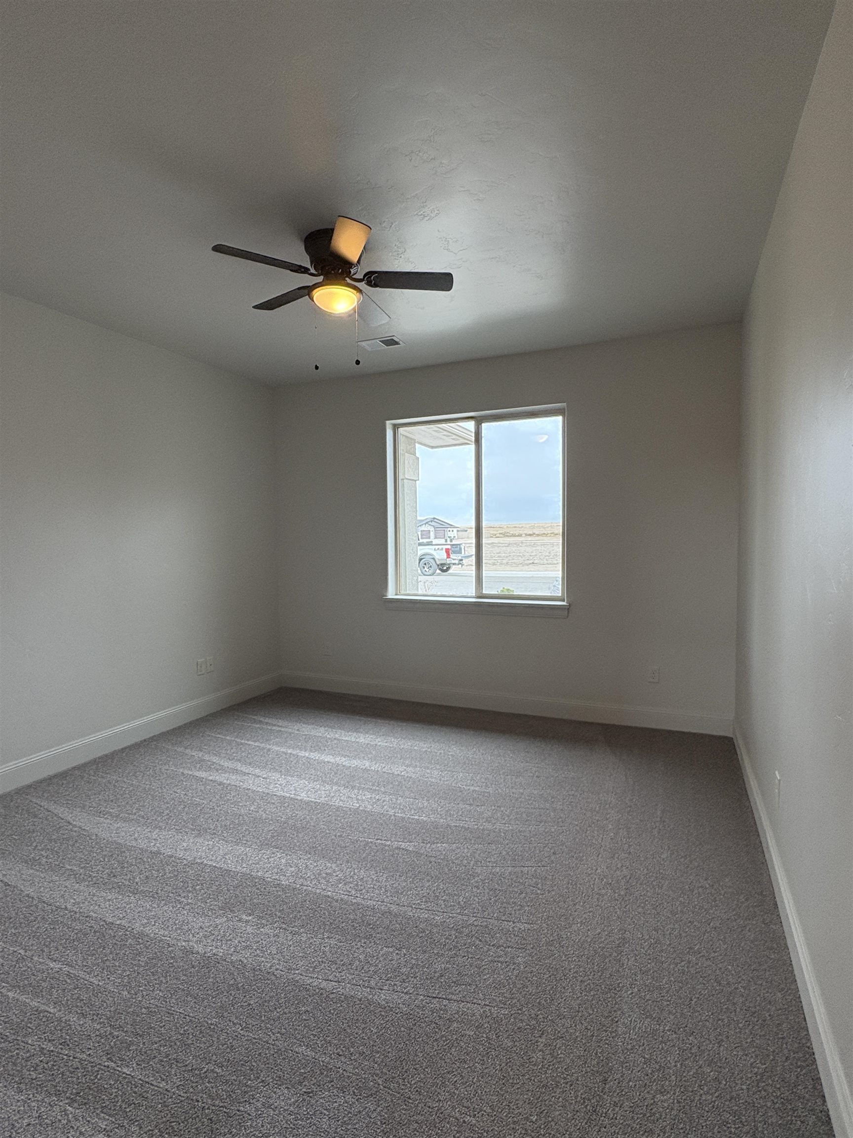 2629 Emerald Ridge Lane Grand Junction, CO 81506 - Photo 23 of 36 a view of an empty room with a window