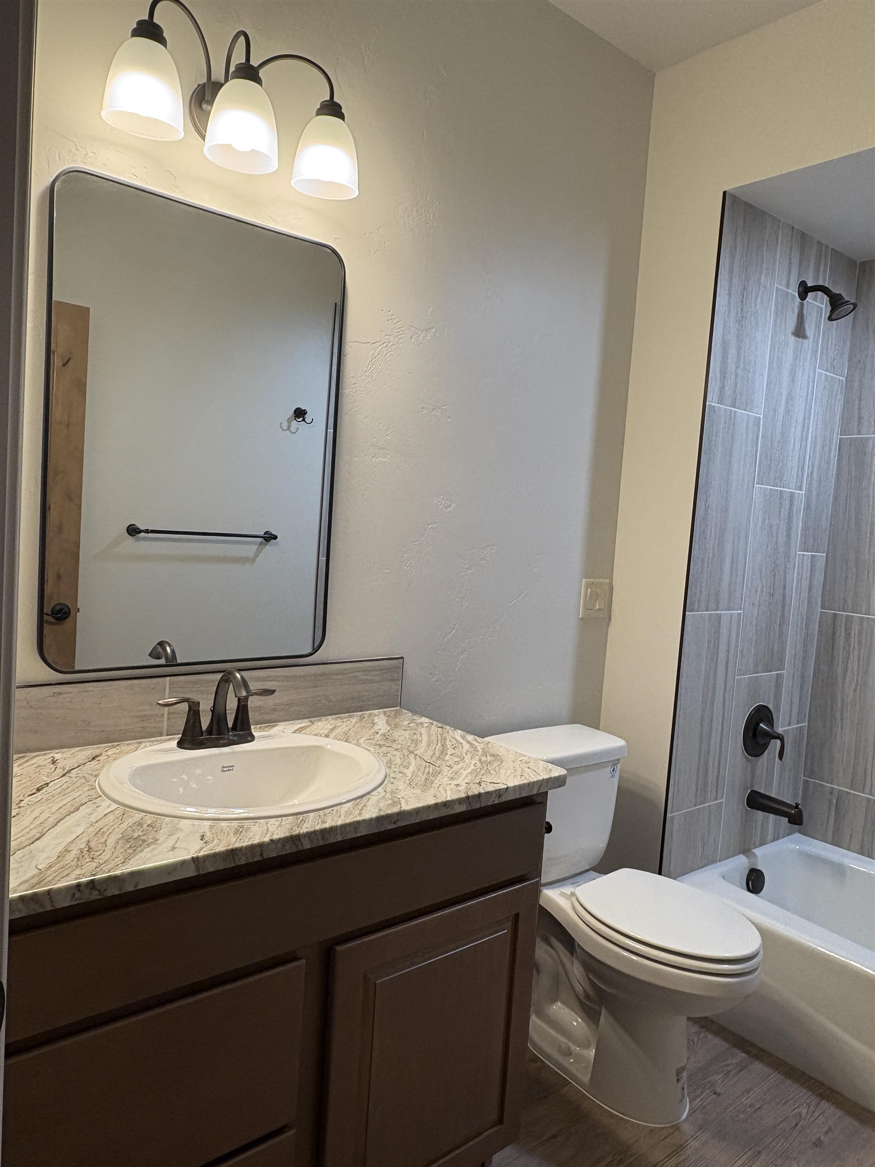 2629 Emerald Ridge Lane Grand Junction, CO 81506 - Photo 25 of 36 a bathroom with a granite countertop toilet sink and mirror