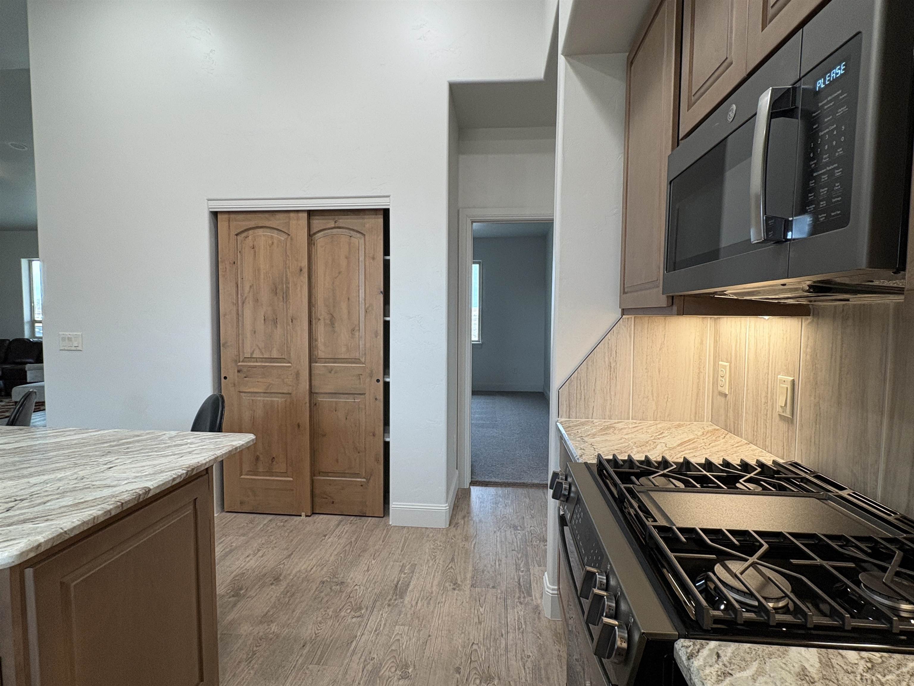 2629 Emerald Ridge Lane Grand Junction, CO 81506 - Photo 33 of 36 a kitchen with wooden floor and a stove top oven