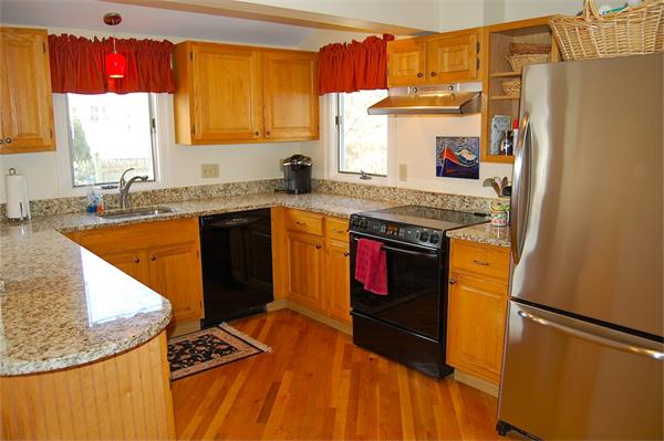 39 Shetland Road Marblehead, MA 01945 - Photo 3 of 12 a kitchen with stainless steel appliances granite countertop a stove a sink and a refrigerator