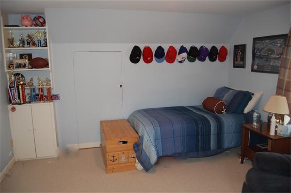 39 Shetland Road Marblehead, MA 01945 - Photo 9 of 12 a bedroom with a bed and a book shelf