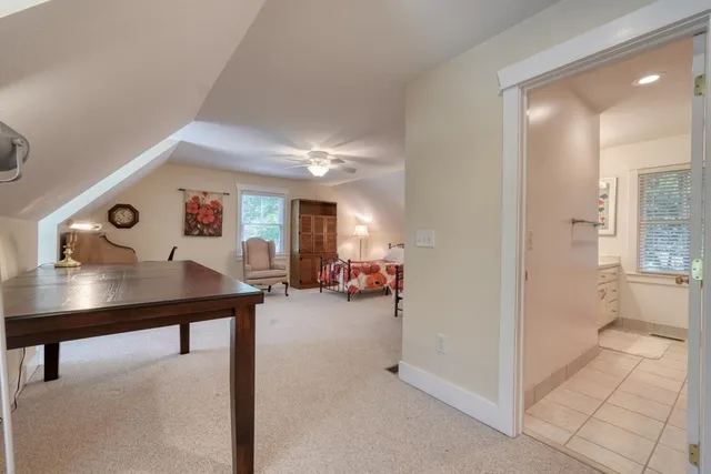 a view of a chairs and tables in the patio in front of a house