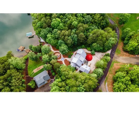 a kitchen with white cabinets and clock on the wall